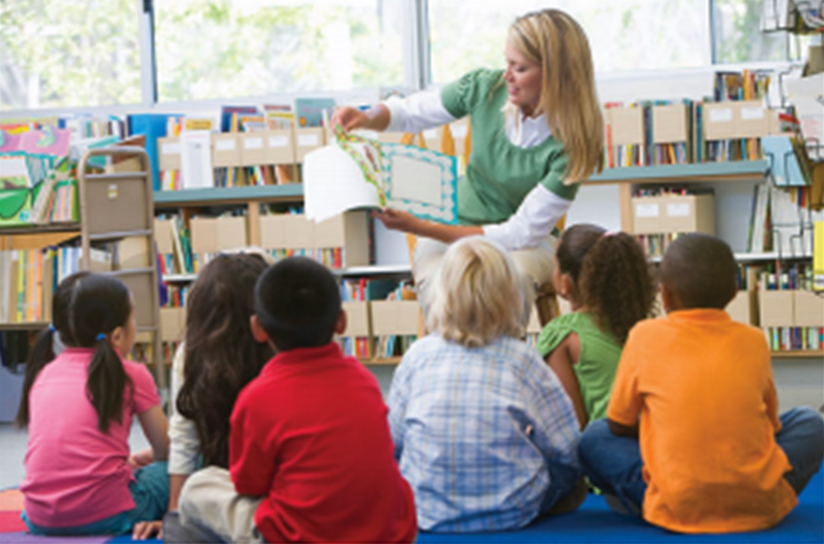 Elementary school teacher reading to students Elementary school teacher reading to students